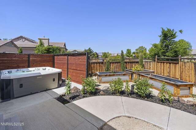 3128 Wild Iris Ct, Sparks, NV 89436 - fenced backyard with a hot tub, a vegetable garden, and a patio area