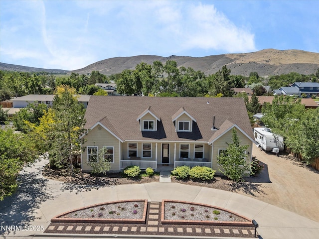 4903 Killdeer Rd, Carson City, NV 89701 - view of front of home featuring covered porch, a mountain view, and a shingled roof
