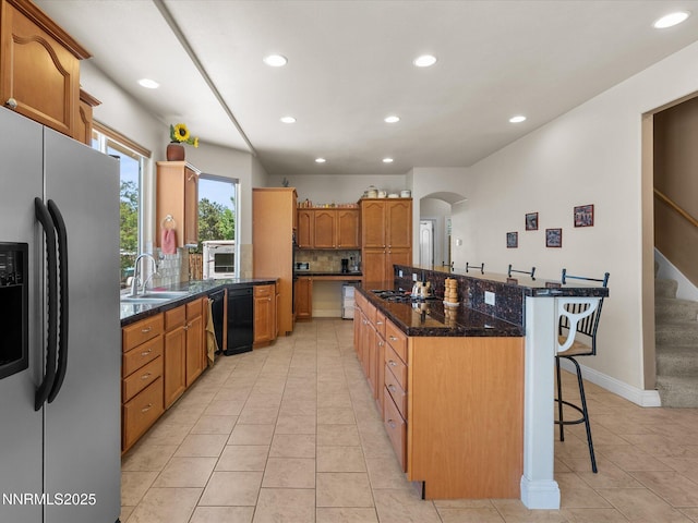 4903 Killdeer Rd, Carson City, NV 89701 - kitchen with stainless steel refrigerator with ice dispenser, a center island, recessed lighting, a kitchen bar, and light tile patterned floors