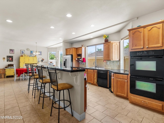 4903 Killdeer Rd, Carson City, NV 89701 - kitchen featuring black appliances, a breakfast bar, decorative backsplash, light tile patterned flooring, and recessed lighting