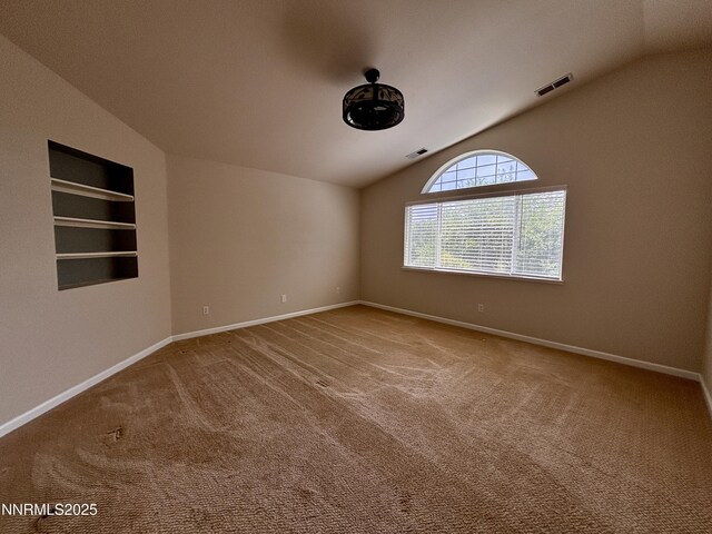 3882 Streamside Ct, Reno, NV 89519 - empty room featuring vaulted ceiling, carpet floors, and built in features