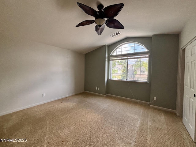 3882 Streamside Ct, Reno, NV 89519 - unfurnished bedroom featuring lofted ceiling, light carpet, and ceiling fan