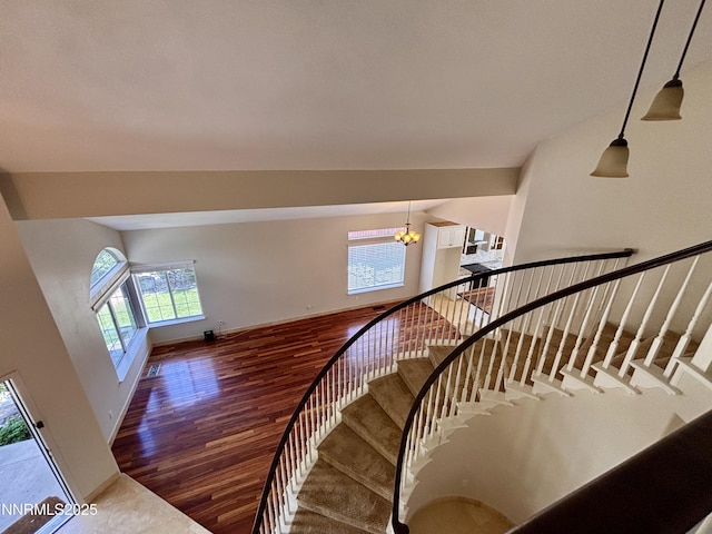 3882 Streamside Ct, Reno, NV 89519 - stairway featuring wood finished floors and a chandelier