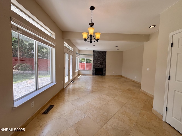 3882 Streamside Ct, Reno, NV 89519 - unfurnished living room featuring a chandelier, a fireplace, stone tile flooring, recessed lighting, and french doors
