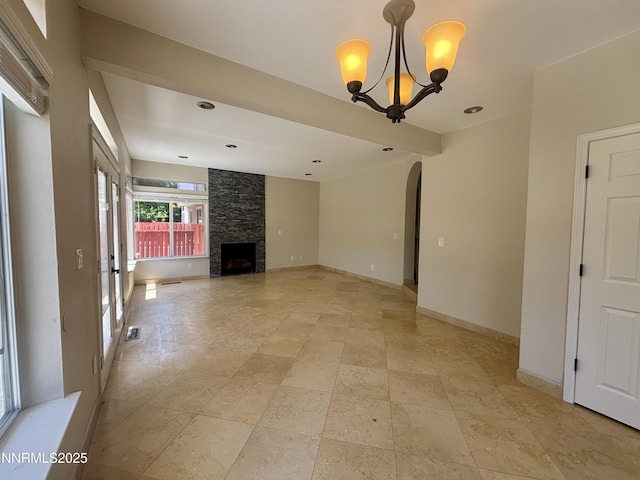 3882 Streamside Ct, Reno, NV 89519 - unfurnished living room featuring arched walkways, a chandelier, and a fireplace