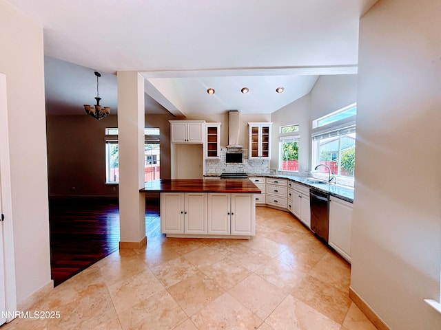 3882 Streamside Ct, Reno, NV 89519 - kitchen with wall chimney exhaust hood, dishwasher, wood counters, a chandelier, and white cabinetry