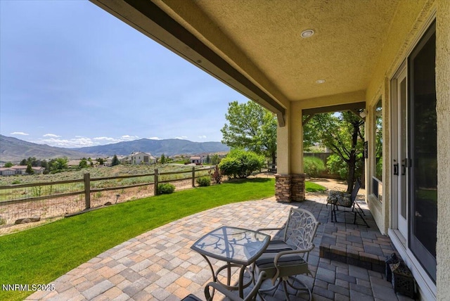 8692 18th Hole Trl, Reno, NV 89523 - fenced backyard featuring a mountain view and a patio area