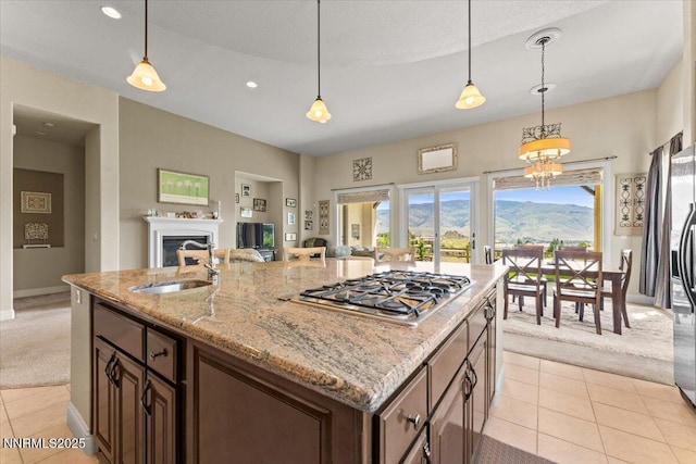 8692 18th Hole Trl, Reno, NV 89523 - kitchen featuring stainless steel gas cooktop, light carpet, light tile patterned floors, open floor plan, and recessed lighting