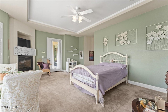 8692 18th Hole Trl, Reno, NV 89523 - carpeted bedroom featuring a raised ceiling, a glass covered fireplace, ceiling fan, and crown molding