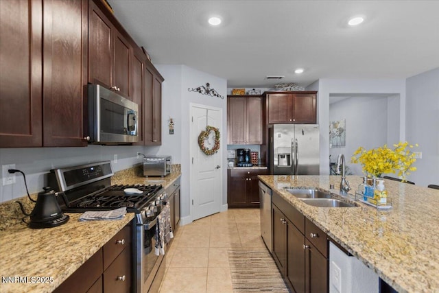 7324 Continuum Dr, Reno, NV 89506 - kitchen with appliances with stainless steel finishes, light stone countertops, light tile patterned flooring, recessed lighting, and dark brown cabinetry