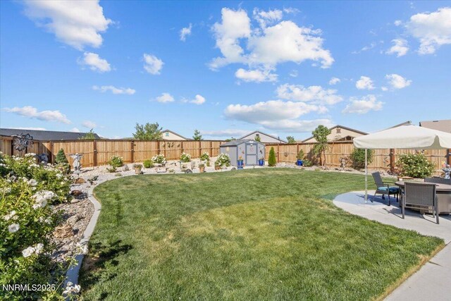 7324 Continuum Dr, Reno, NV 89506 - fenced backyard featuring a storage unit and a patio area