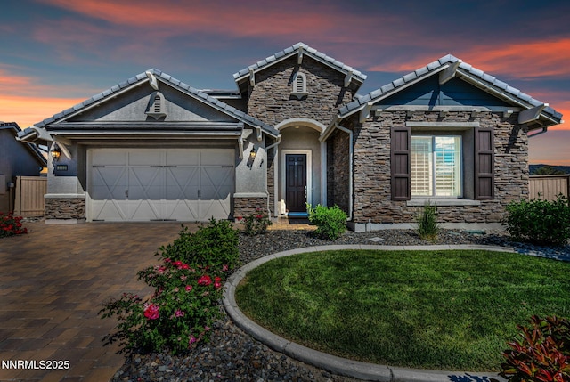 2222 Nasrullah Ln, Reno, NV 89521 - craftsman inspired home with stone siding, a tile roof, a garage, stucco siding, and decorative driveway