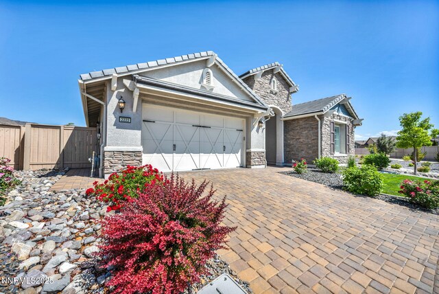 2222 Nasrullah Ln, Reno, NV 89521 - view of front of home with stone siding, an attached garage, and stucco siding
