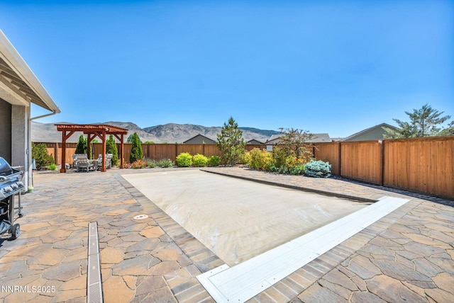2222 Nasrullah Ln, Reno, NV 89521 - fenced backyard featuring a pergola, a patio, and a mountain view
