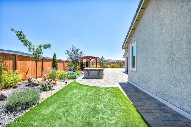 2222 Nasrullah Ln, Reno, NV 89521 - fenced backyard featuring a hot tub, a patio area, and a pergola