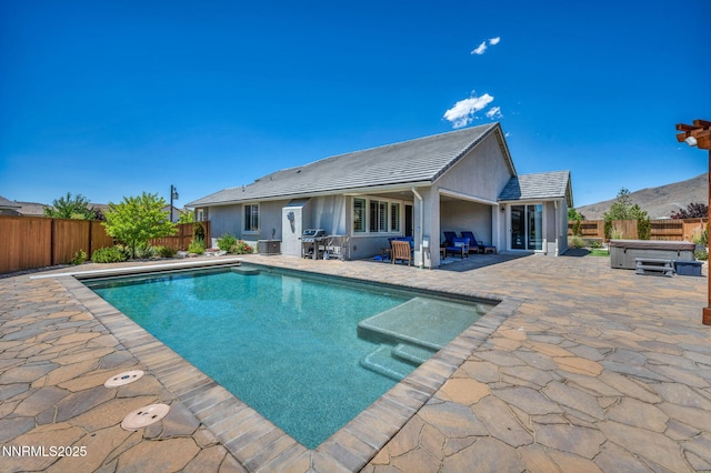 2222 Nasrullah Ln, Reno, NV 89521 - view of swimming pool with a hot tub, a patio area, a fenced backyard, and grilling area