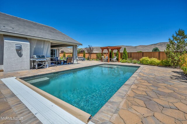 2222 Nasrullah Ln, Reno, NV 89521 - view of swimming pool featuring a pergola, a fenced backyard, a patio, and a mountain view