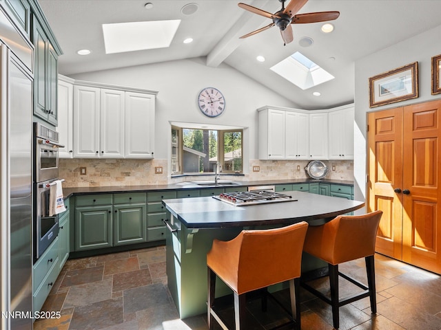 275 Deer Ct, Incline Village, NV 89451 - kitchen with a skylight, green cabinets, white cabinetry, stainless steel gas cooktop, and recessed lighting