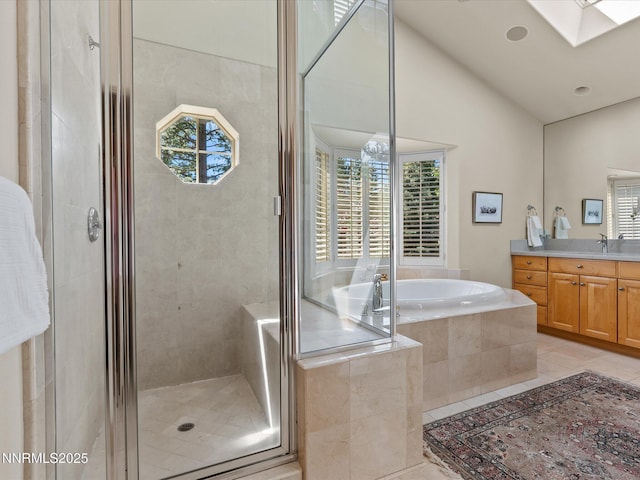 275 Deer Ct, Incline Village, NV 89451 - full bath featuring vanity, a skylight, a bath, a stall shower, and vaulted ceiling