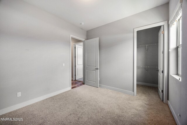 698 Raptor Way, Fernley, NV 89408 - unfurnished bedroom featuring carpet floors, a walk in closet, and a closet