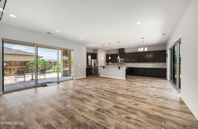 698 Raptor Way, Fernley, NV 89408 - unfurnished living room featuring light wood-type flooring, a chandelier, and recessed lighting
