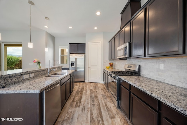 698 Raptor Way, Fernley, NV 89408 - kitchen with stainless steel appliances, light wood finished floors, decorative backsplash, recessed lighting, and dark brown cabinets