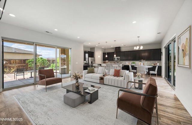 698 Raptor Way, Fernley, NV 89408 - living room with light wood finished floors, a chandelier, and recessed lighting