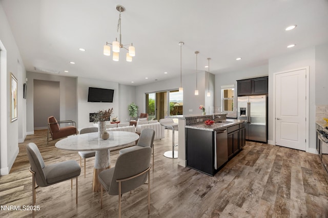 698 Raptor Way, Fernley, NV 89408 - dining room with light wood-style flooring, a chandelier, and recessed lighting