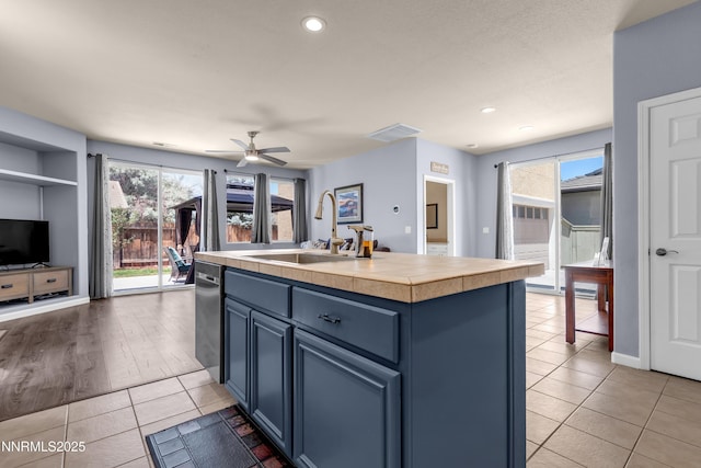 10509 Yuba Ct, Reno, NV 89521 - kitchen featuring blue cabinetry, light tile patterned floors, a ceiling fan, recessed lighting, and a kitchen island with sink