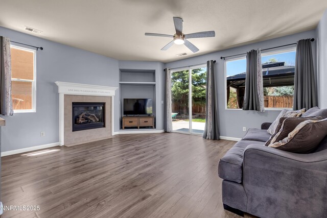 10509 Yuba Ct, Reno, NV 89521 - living room featuring a fireplace, wood finished floors, ceiling fan, and built in features