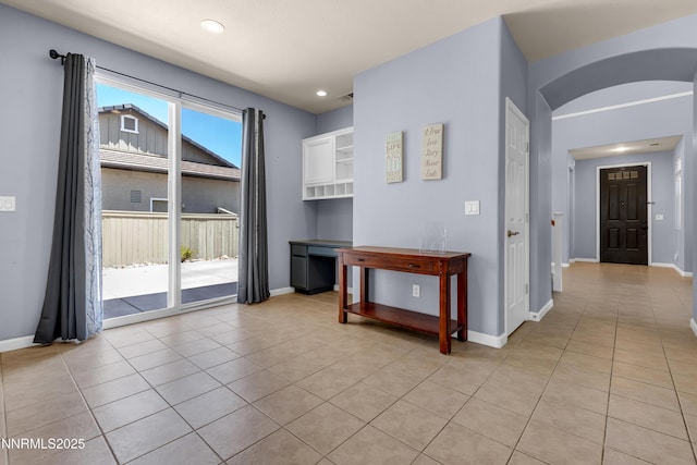10509 Yuba Ct, Reno, NV 89521 - empty room featuring light tile patterned floors, arched walkways, and recessed lighting