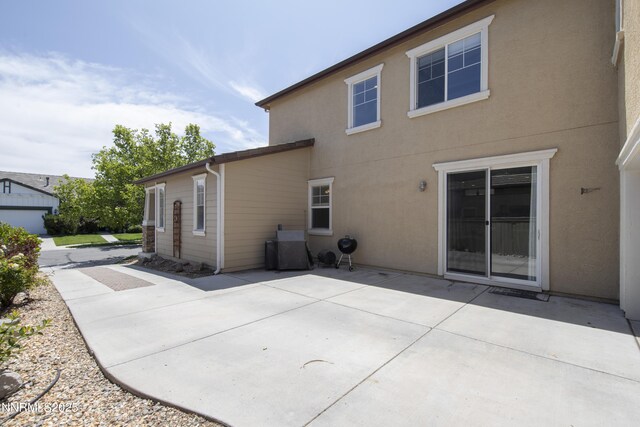 10509 Yuba Ct, Reno, NV 89521 - back of house featuring stucco siding and a patio area