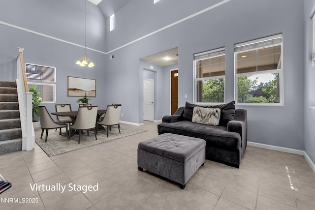 10509 Yuba Ct, Reno, NV 89521 - living room featuring a chandelier, light tile patterned flooring, stairs, and a towering ceiling