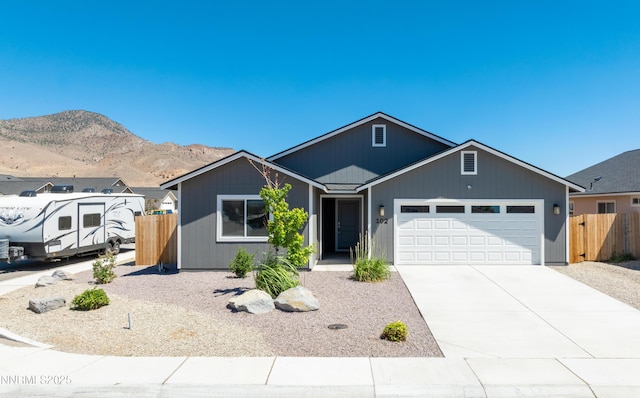 102 Halite Dr, Dayton, NV 89403 - ranch-style house featuring a garage, driveway, and a mountain view