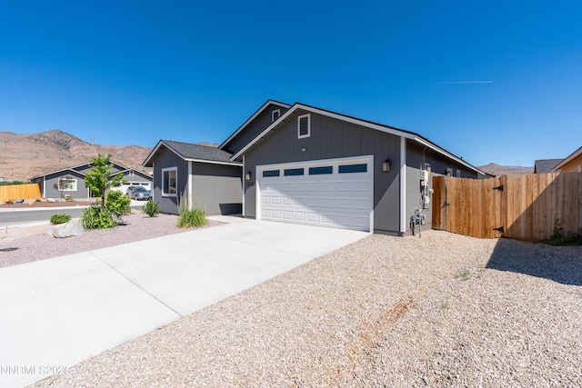 102 Halite Dr, Dayton, NV 89403 - ranch-style home with an attached garage, driveway, and a mountain view