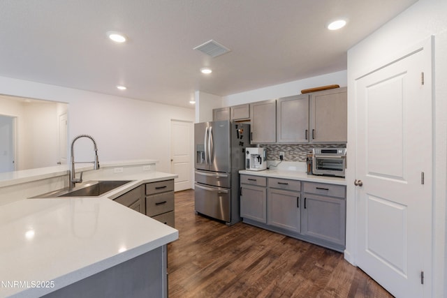 102 Halite Dr, Dayton, NV 89403 - kitchen featuring stainless steel fridge, gray cabinets, dark wood-style floors, light countertops, and backsplash