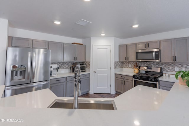 102 Halite Dr, Dayton, NV 89403 - kitchen featuring stainless steel appliances, light countertops, decorative backsplash, recessed lighting, and dark wood-type flooring