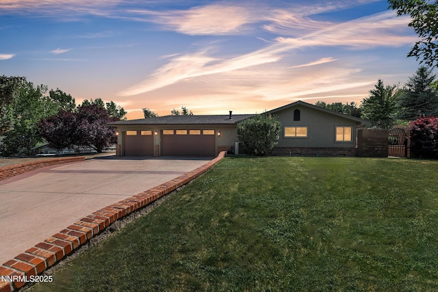 1401 Jefferson Dr, Carson City, NV 89706 - view of front of property featuring an attached garage, concrete driveway, a front yard, and stucco siding