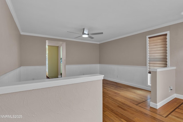 1401 Jefferson Dr, Carson City, NV 89706 - spare room featuring wood finished floors, a ceiling fan, wainscoting, and crown molding