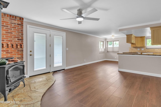 1401 Jefferson Dr, Carson City, NV 89706 - kitchen with a wood stove, crown molding, a ceiling fan, wood finished floors, and tasteful backsplash