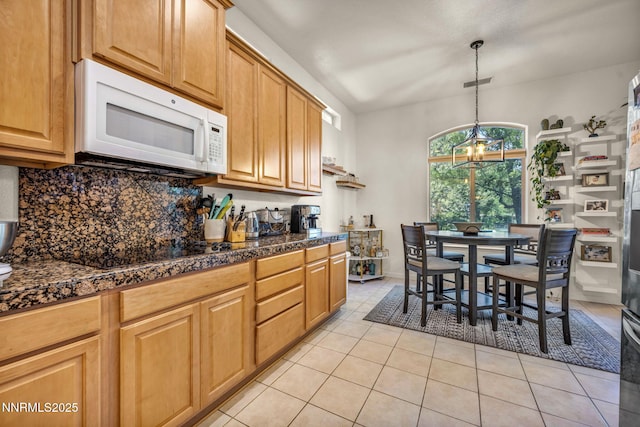 9900 Wilbur May Pkwy Apt 5102, Reno, NV 89521 - kitchen featuring white microwave, tile counters, black electric cooktop, decorative backsplash, and light tile patterned floors