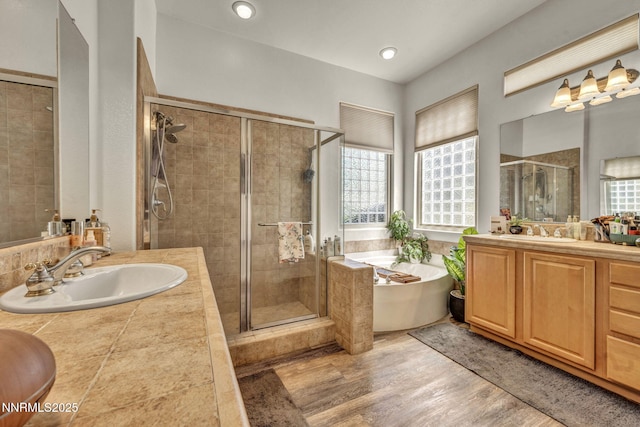 9900 Wilbur May Pkwy Apt 5102, Reno, NV 89521 - bathroom with a soaking tub, a stall shower, healthy amount of natural light, and two vanities
