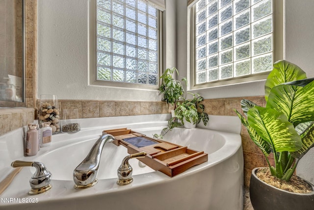 9900 Wilbur May Pkwy Apt 5102, Reno, NV 89521 - full bathroom featuring plenty of natural light, a garden tub, and a textured wall