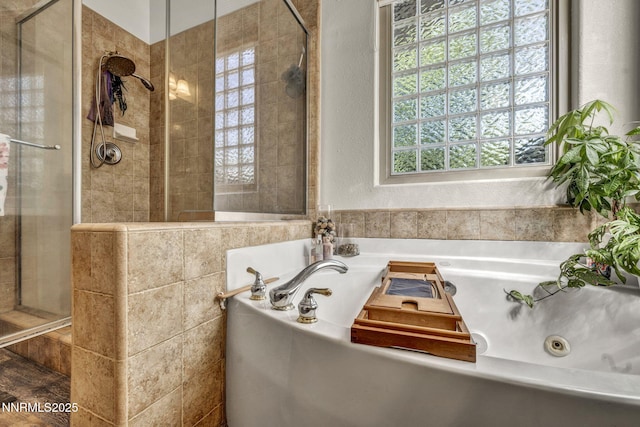 9900 Wilbur May Pkwy Apt 5102, Reno, NV 89521 - bathroom featuring a shower stall, a jetted tub, a textured wall, and tile walls