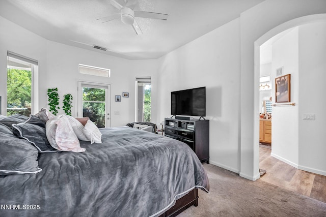 9900 Wilbur May Pkwy Apt 5102, Reno, NV 89521 - bedroom featuring arched walkways, light colored carpet, access to exterior, and ceiling fan
