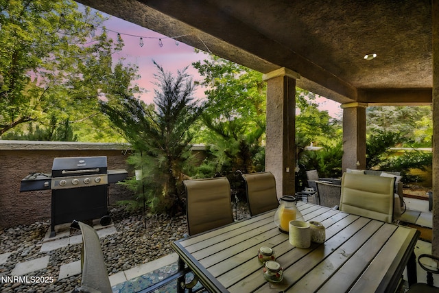9900 Wilbur May Pkwy Apt 5102, Reno, NV 89521 - patio terrace at dusk with outdoor dining area and area for grilling