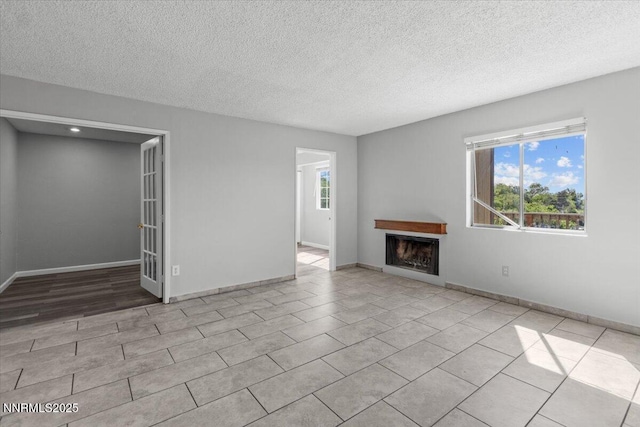 2090 Highview Ct Unit 7, Reno, NV 89512 - unfurnished living room with a fireplace, a textured ceiling, and tile patterned flooring