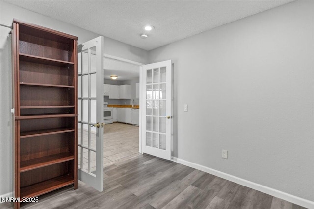 2090 Highview Ct Unit 7, Reno, NV 89512 - empty room featuring french doors, wood finished floors, a textured ceiling, and a smoke detector