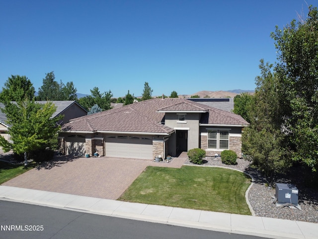 4883 Brunello Dr, Sparks, NV 89436 - prairie-style house with a garage, stone siding, decorative driveway, and a front yard