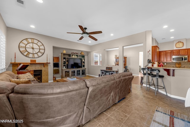 4883 Brunello Dr, Sparks, NV 89436 - living area featuring a ceiling fan, a tiled fireplace, light tile patterned floors, and recessed lighting